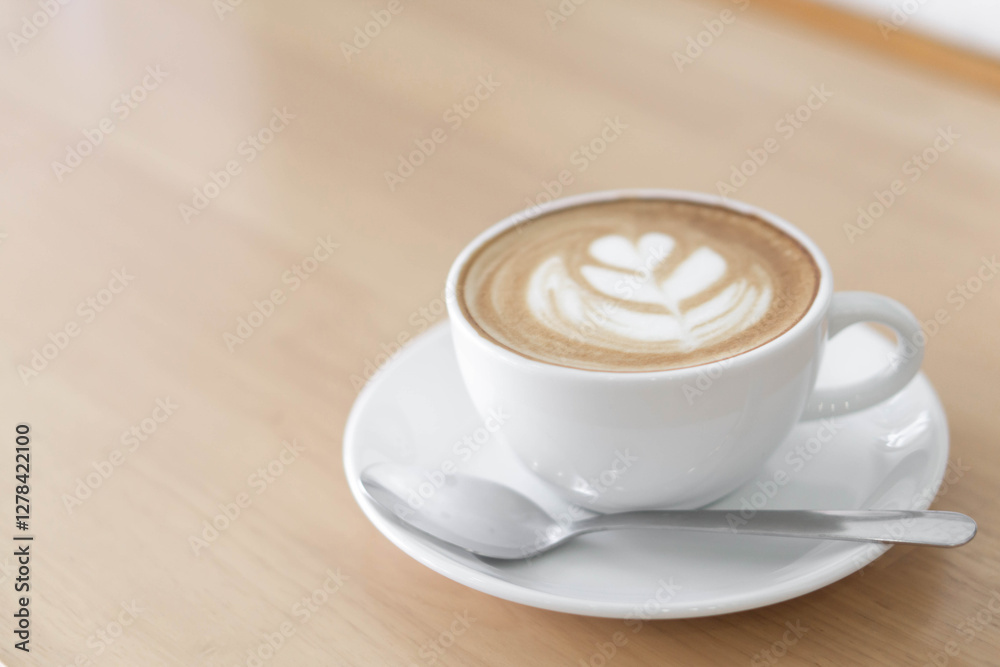 A beautifully crafted latte art in a white ceramic cup, featuring delicate leaf latte art on its creamy surface. A beautifully crafted latte art in a white ceramic cup, featuring delicate leaf latte art on its creamy surface.