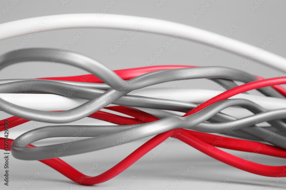Many electrical wires on light grey background, closeup Many electrical wires on light grey background, closeup
