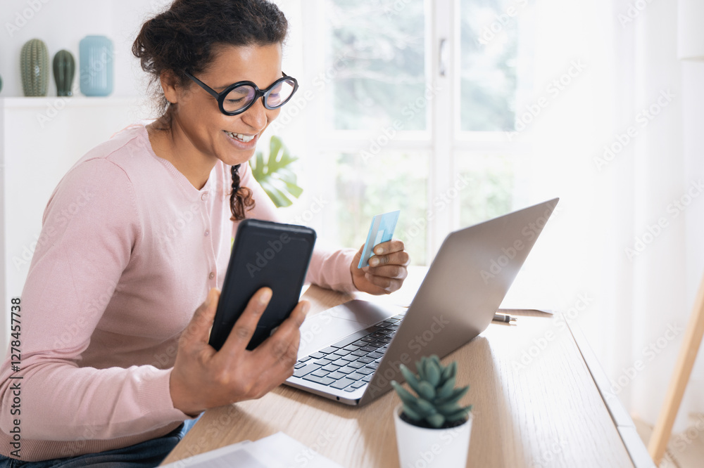 Happy black woman making credit card online payment Happy black woman making credit card online payment