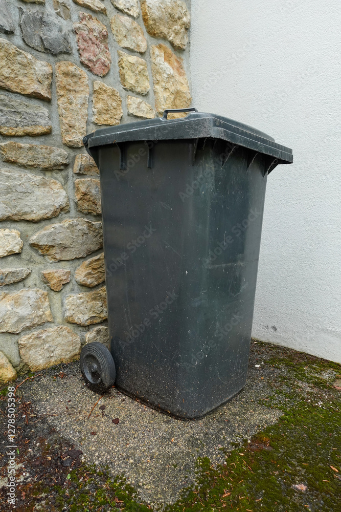 Outdoor Garbage Bin Against Stone Wall Outdoor Garbage Bin Against Stone Wall