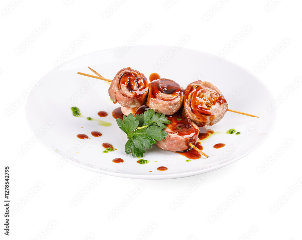 A white plate with meat skewers and sauce on a white background A white plate with meat skewers and sauce on a white background