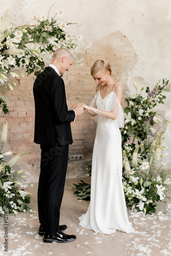 Young beautiful couple getting engaged at the arch