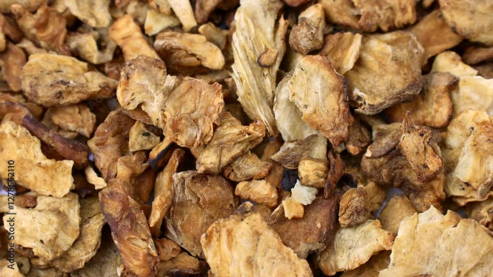 Brown dried chicory root slices circle rotation close up Brown dried chicory root slices circle rotation close up