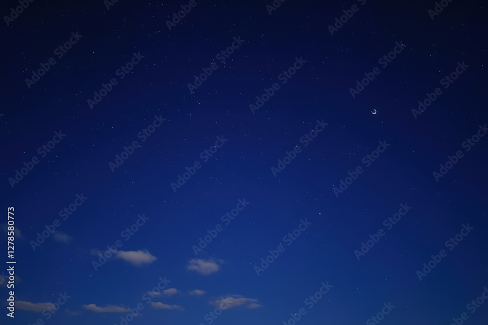 Naklejka premium Celestial Serenity: Moonlit Night Sky with Scattered Stars, moon and Tranquil Atmosphere.