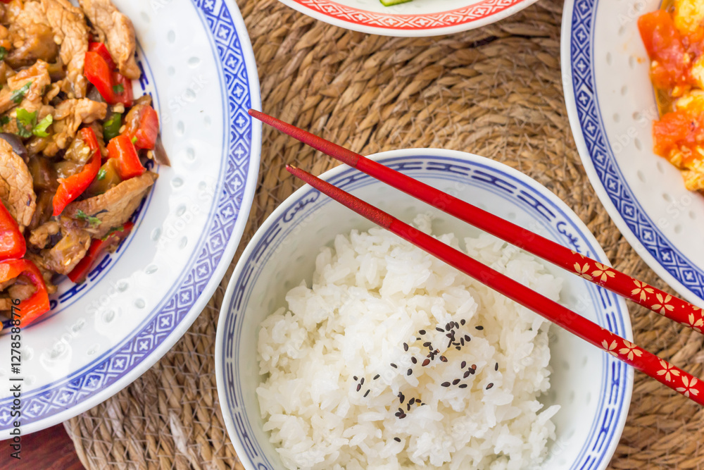 Chinese chopsticks on a bowl with white rice