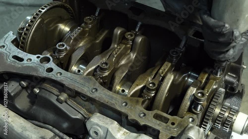Engine repair. Auto mechanic working on car engine in mechanics garage. Repair auto service. Hands of car mechanic with wrench in car service station close-up shot.Professional mechanic with motor car