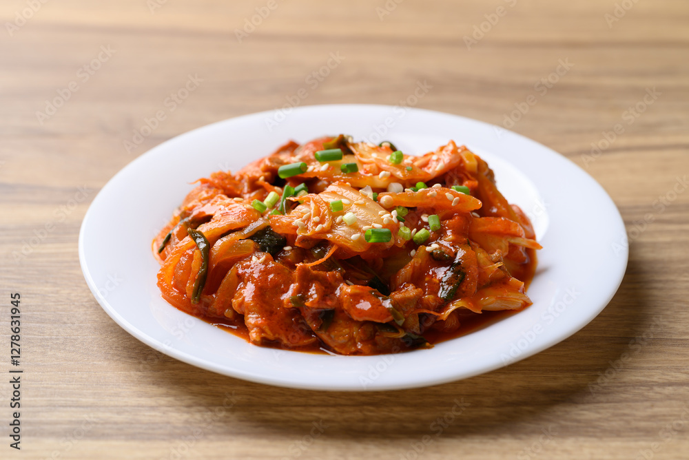 Stir fried kimchi cabbage with pork on plate, Korean food Stir fried kimchi cabbage with pork on plate, Korean food