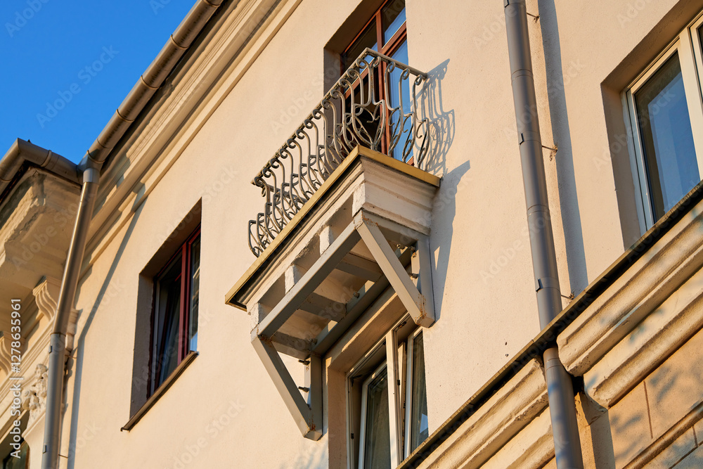 Small balcony with under reconstruction and renovation works, balcony railing with detailed ornamental design, sturdy iron support beams. Compact decorative balcony with strong structural support Small balcony with under reconstruction and renovation works, balcony railing with detailed ornamental design, sturdy iron support beams. Compact decorative balcony with strong structural support