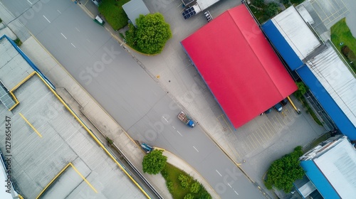 Aerial View of Street Scene with Red Roof Building and Person on Vehicle