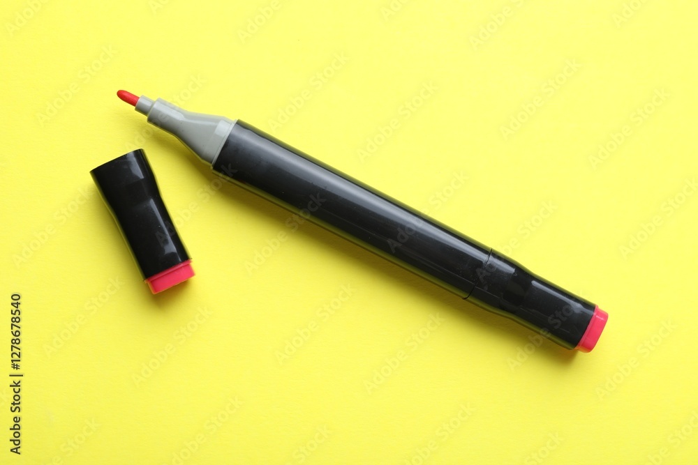 One double sided marker on yellow background, top view One double sided marker on yellow background, top view
