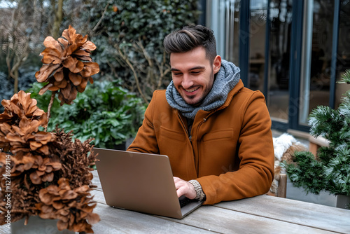 Smiling Man Working on Lapt...