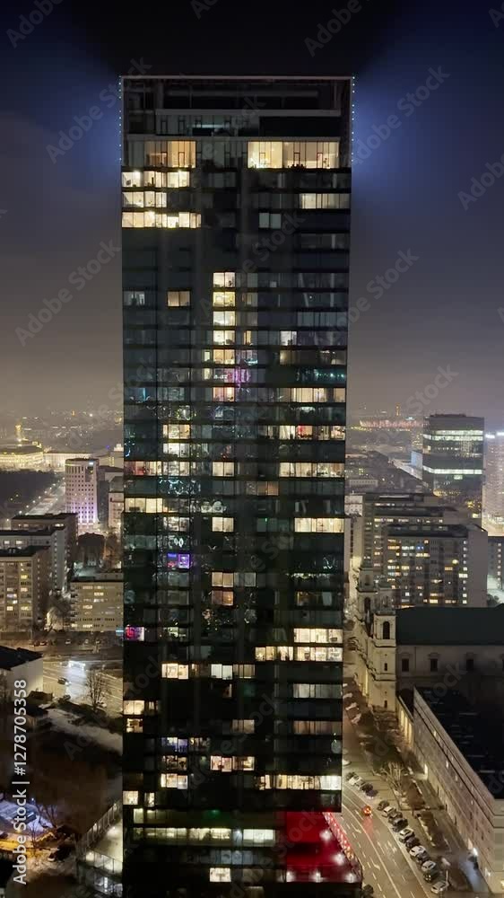 Cityscape night view on a modern office buildings in a downtown, view on a evening city through the window, skyscraper at night, urban background. Cityscape night view on a modern office buildings in a downtown, view on a evening city through the window, skyscraper at night, urban background.