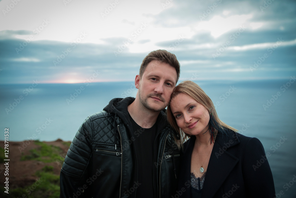 Couple enjoying romantic sunset over atlantic ocean in madeira Couple enjoying romantic sunset over atlantic ocean in madeira
