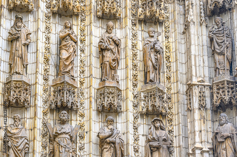 Group of religious saint statues in the facade of the medieval cathedral, Seville, Spain Group of religious saint statues in the facade of the medieval cathedral, Seville, Spain