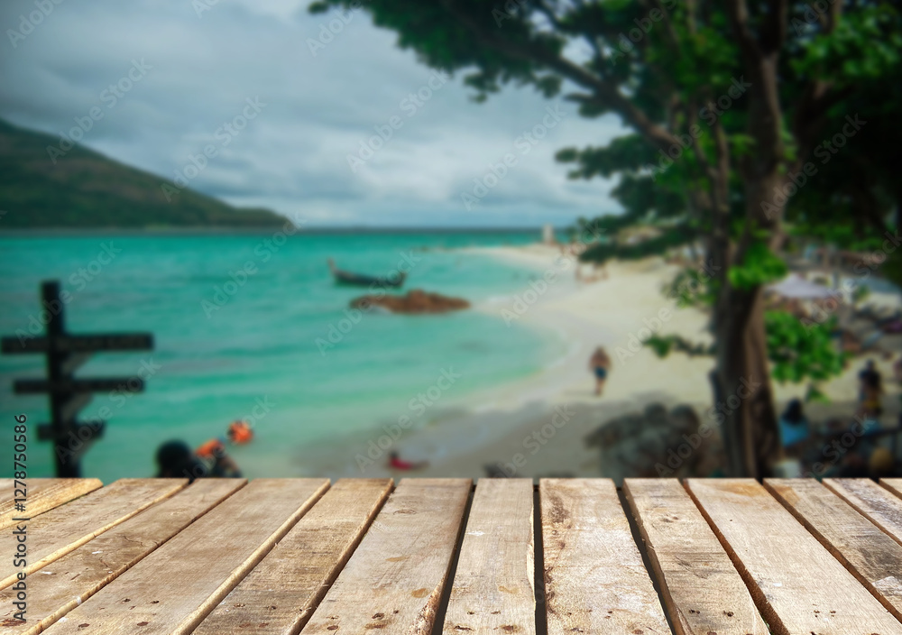 Fototapeta premium Wooden table top on the beach or sea.Party on the beach sunshine time concept.For montage product display or design key visual layout.View of copy space.