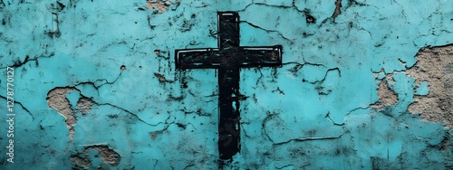 Simple cross graffiti on a turquoise wall
