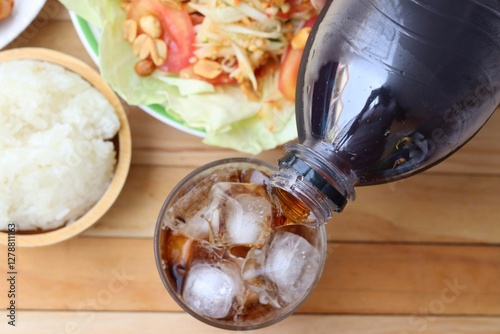 Obraz na płótnie Cola soft drink with ice cubes and papaya salad spicy Thai food w salonie