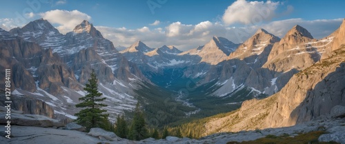 Wallpaper Mural Panoramic view of mountainous landscape with snow-capped peaks and lush green valley under a blue sky with clouds in daylight Torontodigital.ca