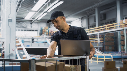 Photography Multiethnic Male Stocking Associate Doing Inventory On Laptop Computer, Checking Delivery Tracking Number On Boxes