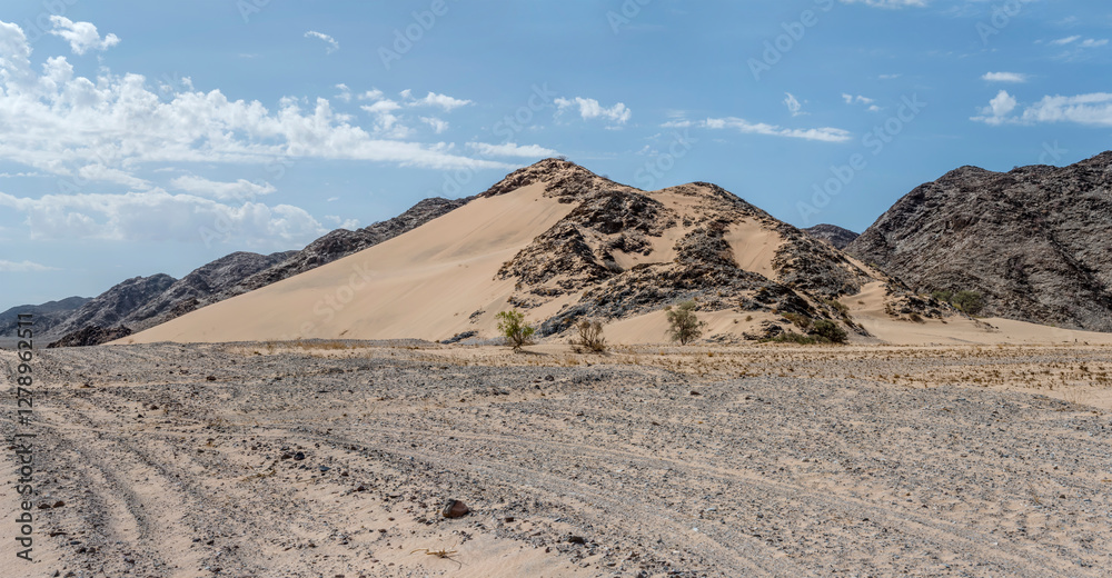 rocky basalt slope covered with sand, near De Riet, Namibia