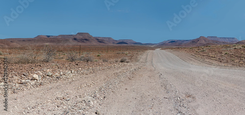 Obraz na płótnie C39 dirt road winding in desert, near Bergsig, Namibia w salonie