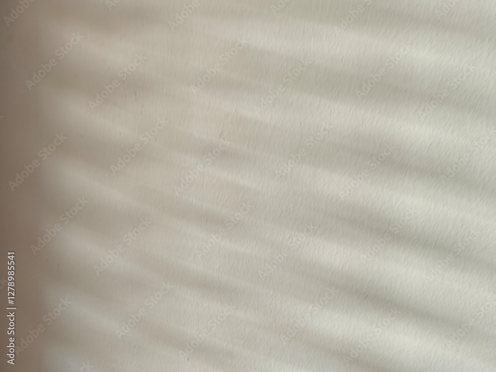 Naklejka premium brushed metal texture Light passes through the blinds and hits the cream-white wall, creating patterns and shadows.