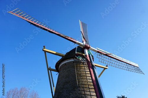 Mill in the Netherlands in Stad aan Haringvliet on Goeree Overflakkee. An old-fashioned wood and stone mill that processed grist and is still in use. Wind energy through the blades.