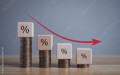 business turnover decreased, interest rate decline, Wood blocks with percentage sign and down arrow on gray background, recession crisis concept.	