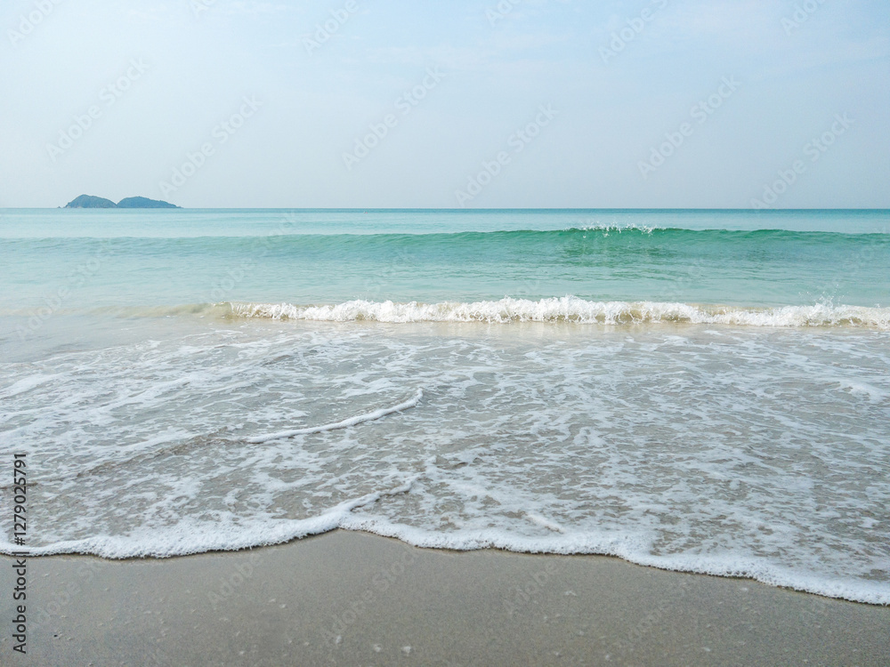Gentle Ocean Waves on a Serene Sandy Beach.