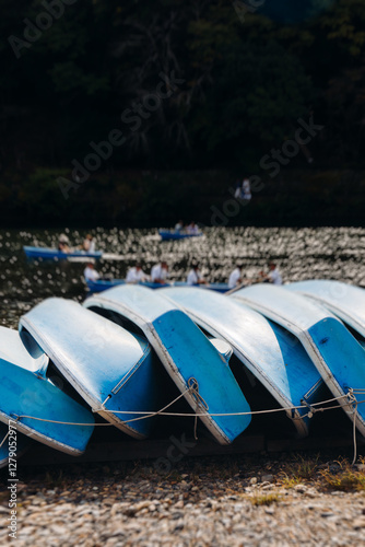 Arashiyama district panorama in western Kyoto, Japan, with boats and mountain Arashi, Togetsukyo bridge, Katsura Hozu River, autumn fall landscape view, travel to Japan, Kansai region, Kyoto photo