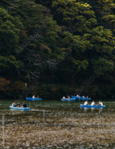 Arashiyama district panorama in western Kyoto, Japan, with boats and mountain Arashi, Togetsukyo bridge, Katsura Hozu River, autumn fall landscape view, travel to Japan, Kansai region, Kyoto photo