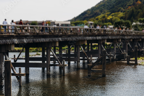 Arashiyama district panorama in western Kyoto, Japan, with boats and mountain Arashi, Togetsukyo bridge, Katsura Hozu River, autumn fall landscape view, travel to Japan, Kansai region, Kyoto photo