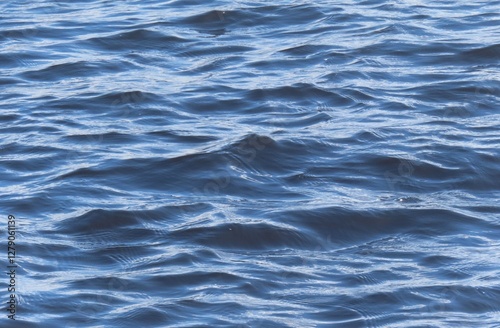 Fototapeta Naklejka Na Ścianę i Meble -  Rolling waves on blue river water surface, natural water background