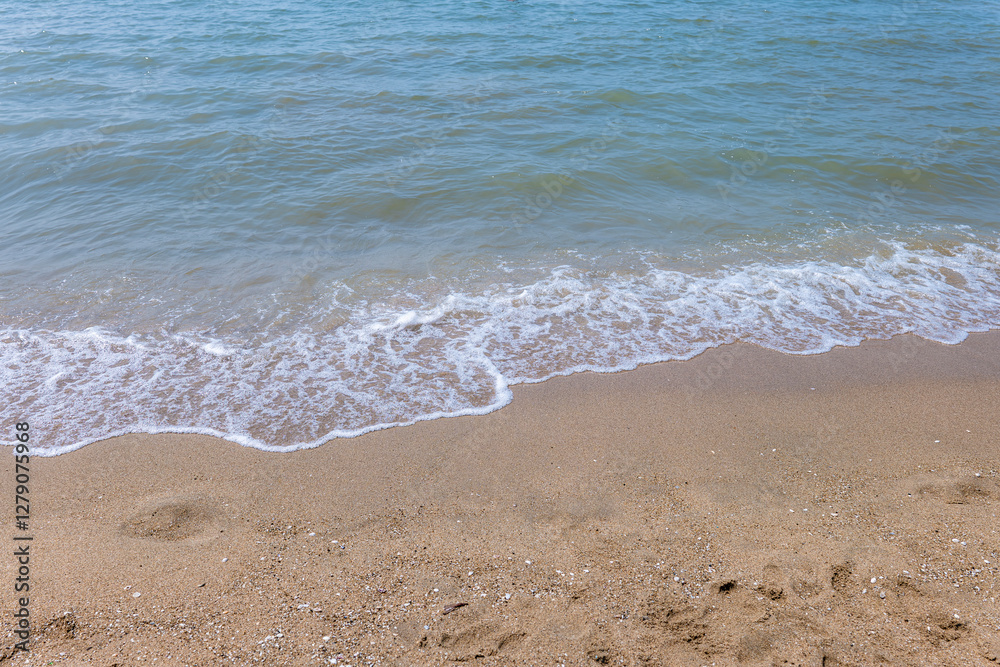 Soft blue ocean wave on clean sandy beach. Copy Space. Background Soft blue ocean wave on clean sandy beach. Copy Space. Background