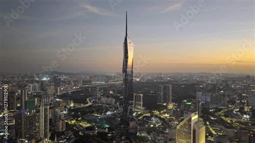 Merdeka 118 megatall skyscraper in Kuala Lumpur, Malaysia at sunset with the sun reflecting off the glass of the building (Aerial ProRes HDR drone video)