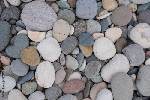 Colorful pebbles on beach. Textures and patterns of smooth round pebbles stones. Top view, close up