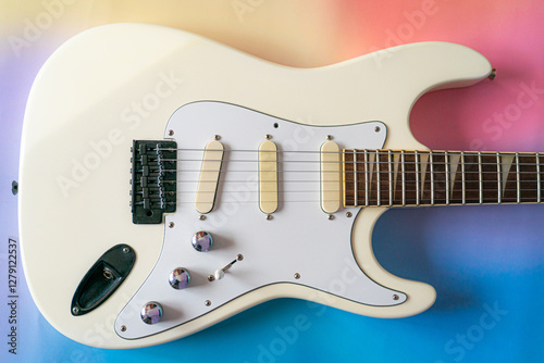 White electric guitar on gradient background