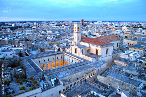 Aerial view of the historic center of Lecce at sunset with the church of Santa Irene and the cloister of the Teatini convent in the foreground. Lecce, Puglia, Italy.