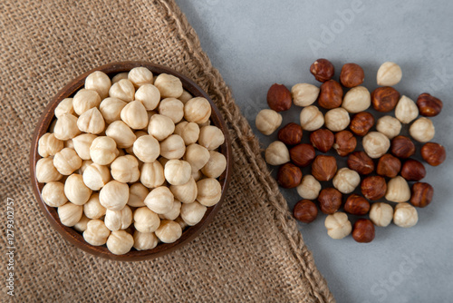 Heap of peeled and shelled hazelnuts on burlap sack,top view