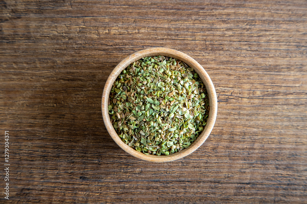 A bowl full of dried and ground organic mountain thyme on wooden table
A bowl full of dried and ground organic mountain thyme on wooden table