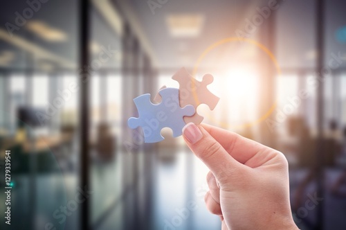 Worker hands holds jigsaw puzzle.