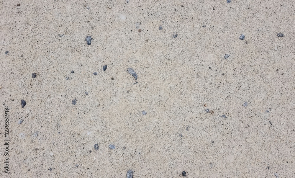 Textured sandy beach with pebbles Textured sandy beach with pebbles