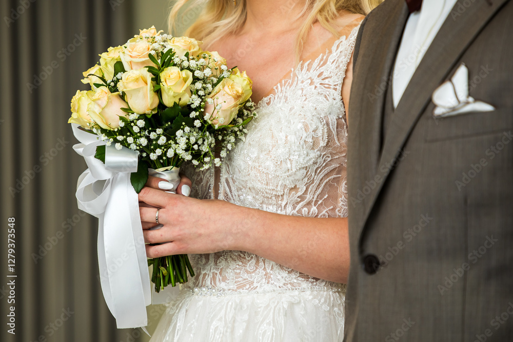 Macro view of bouquet of flowers holding by obscured bride on wedding