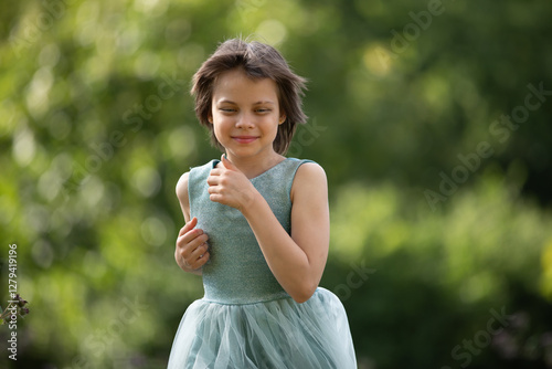 Portrait of little adorable girl walking in park