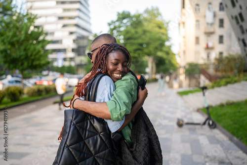 Papier peint Smiling black wife laugh and hug husband tightly, emotional family reunion outdoors