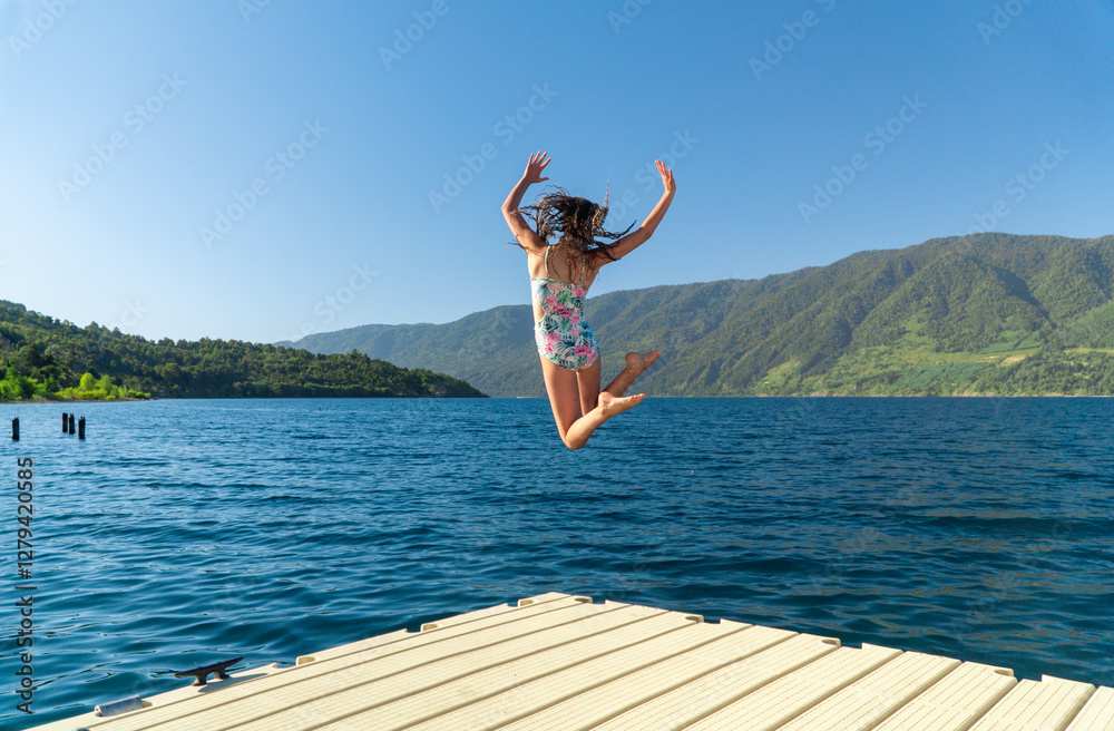 Happy Girl in Swimsuit Jumping off a Dock into the Lake