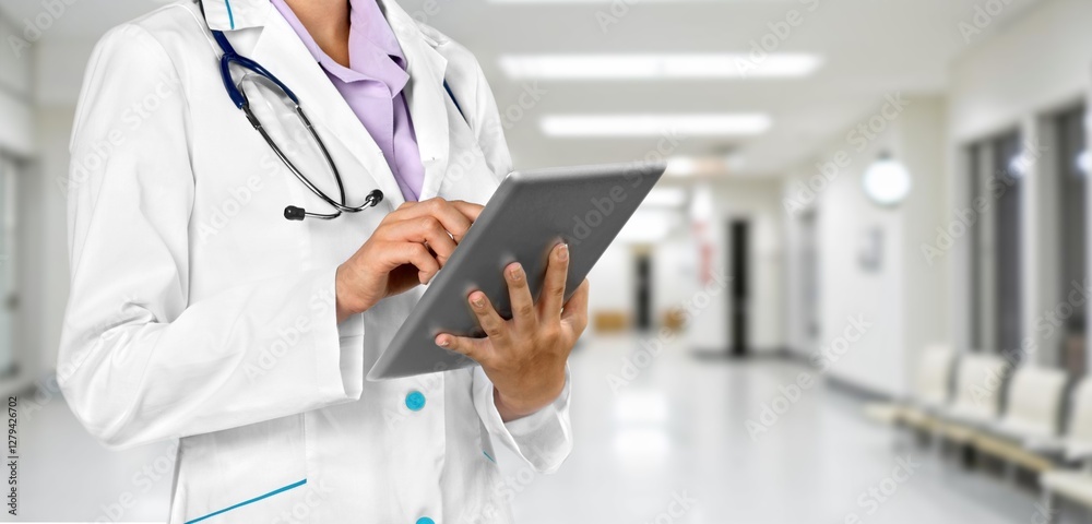 Doctor with arms crossed with stethoscope in clinic Doctor with arms crossed with stethoscope in clinic