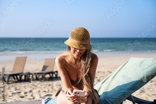 Sticker Tourist using smartphone on beach chair enjoying summer vacation
