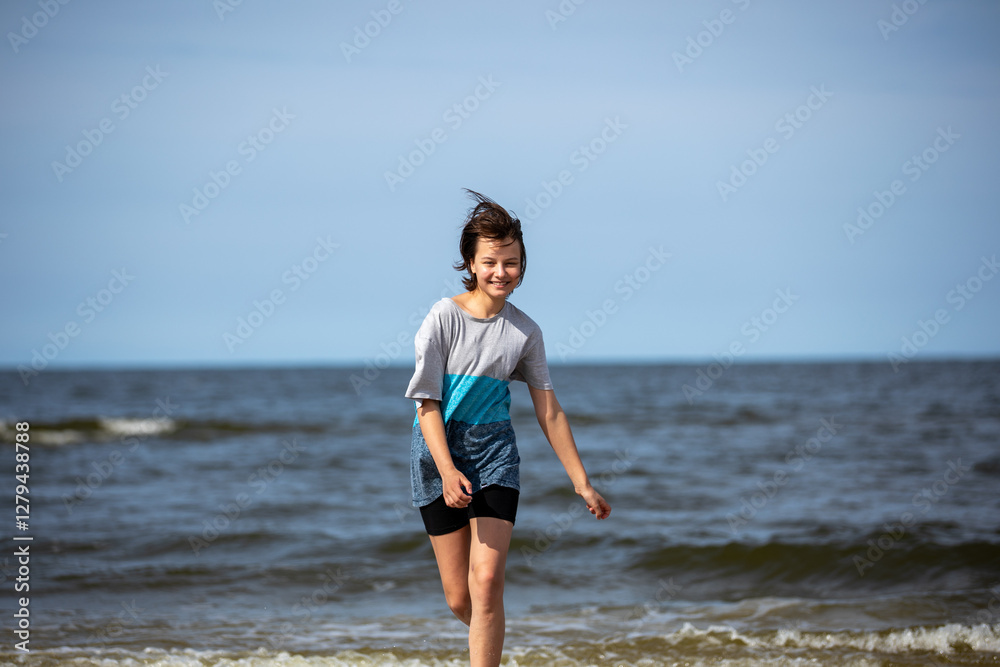 Beautiful girl walking at sea shore