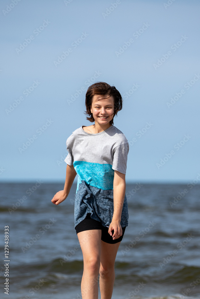 Beautiful girl walking at sea shore